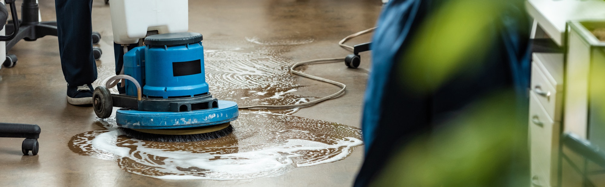 cropped view of cleaner washing floor with cleaning machine, panoramic shot