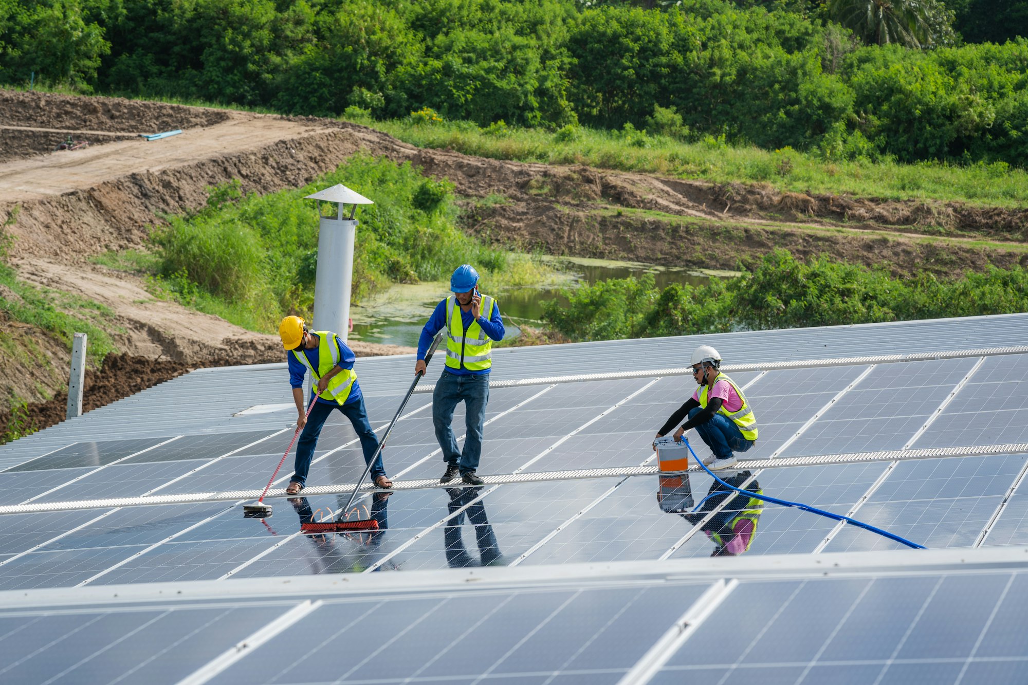 Solar power washing,labor working on cleaning solar panel at solar power plant.